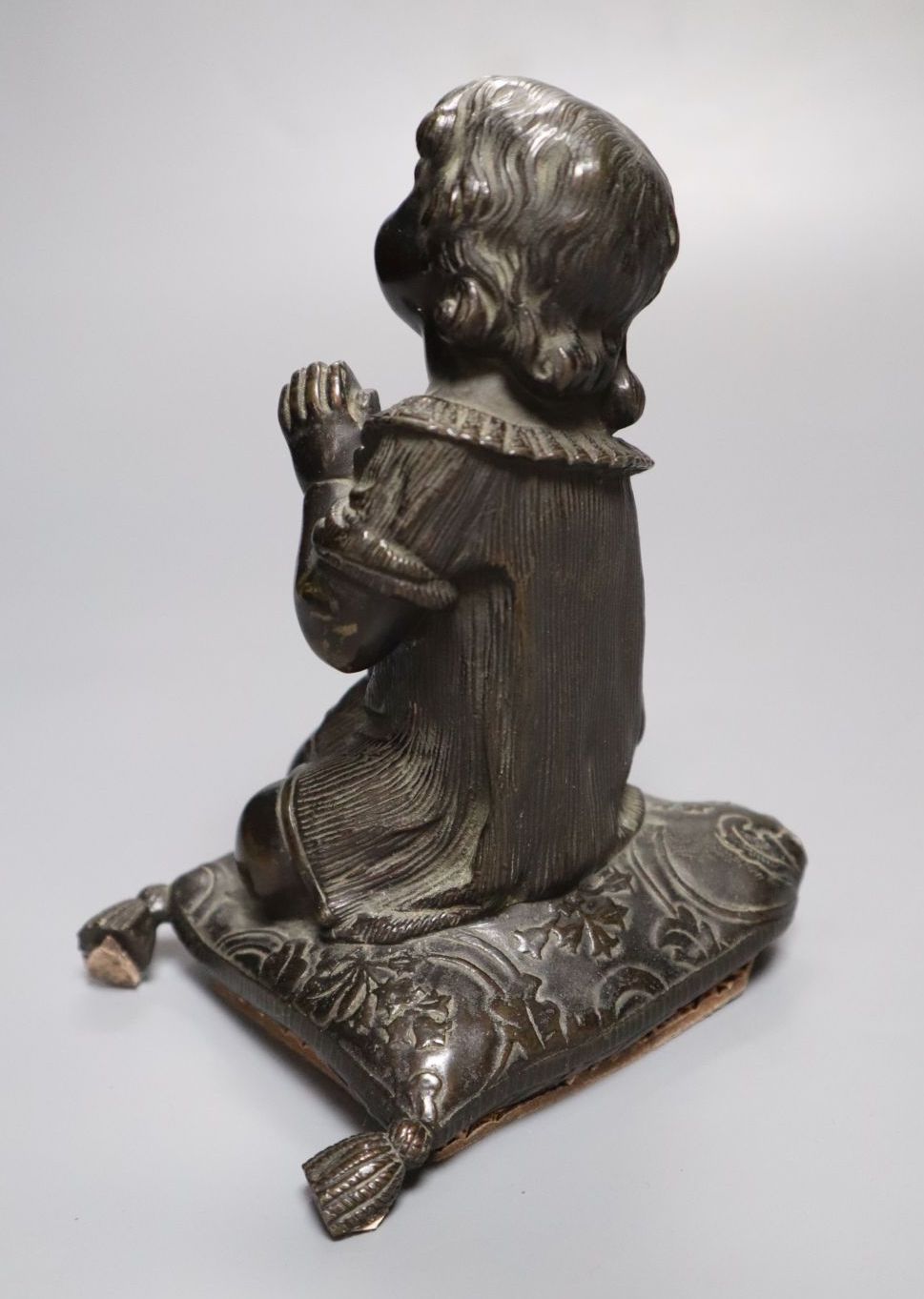 A bronze figure, girl kneeling at prayer, unsigned, 16cm